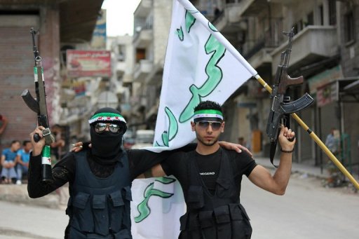 Syrian rebels pose with weapons in a photo released by the opposition news network (AFP-Shaam News Network-File)