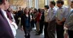 Times Executive Editor Jill Abramson heads for the daily Page One meeting on Feb. 29 as hundreds of journalists and other Guild-represented employees line the hall to silently protest a company proposal to cut their benefits.
