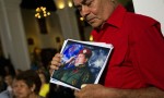 A supporter of Chavez holds a picture of him